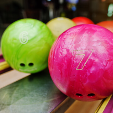 Different color bowling balls on ball return