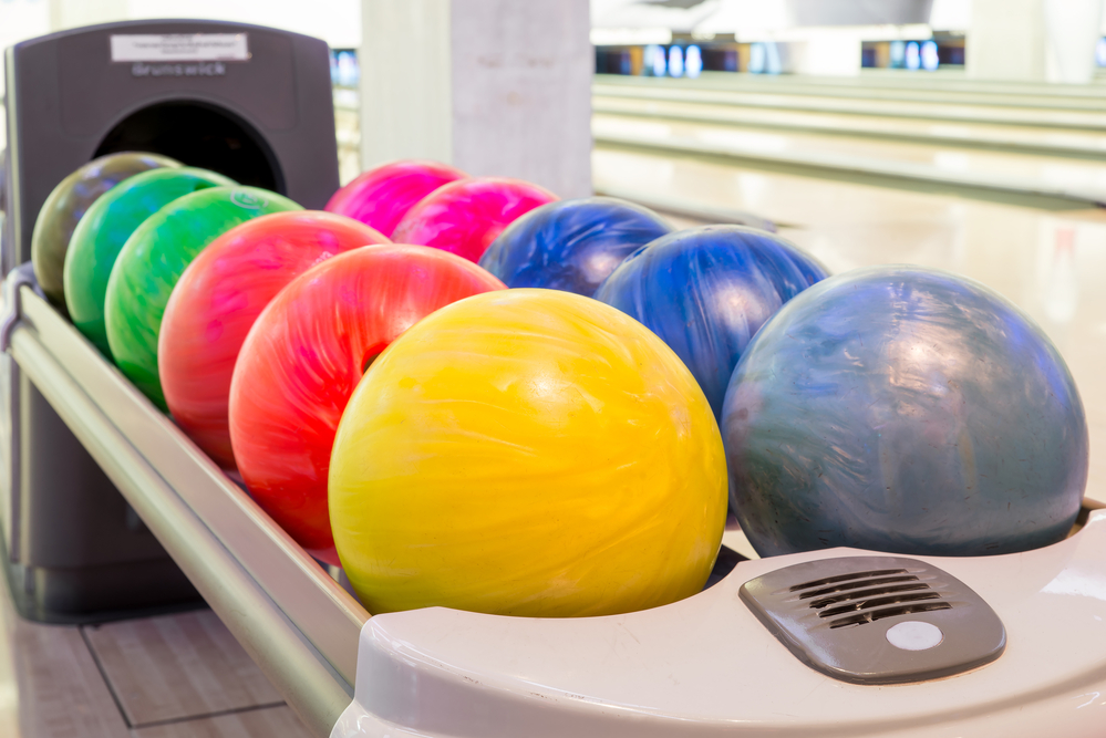 Close-up view of an old bowling ball that is yellow