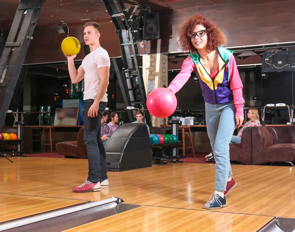 Girl with red hair and pink ball is rolling straight balls so she can later adjust and migrate inside