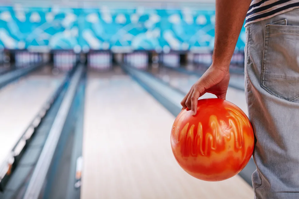 Young guy in casual wear playing bowling sunset strip bowling pattern because member posts said it was available