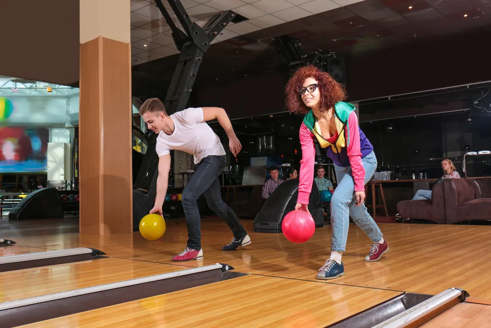 Guy in white shirt with yellow bowling ball is remember to a good rule of thumb- have fun