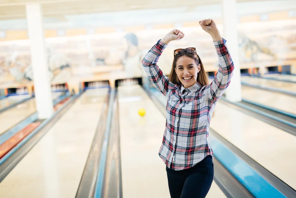 Happy friends having fun and enjoying playing bowling together bowled pba patterns