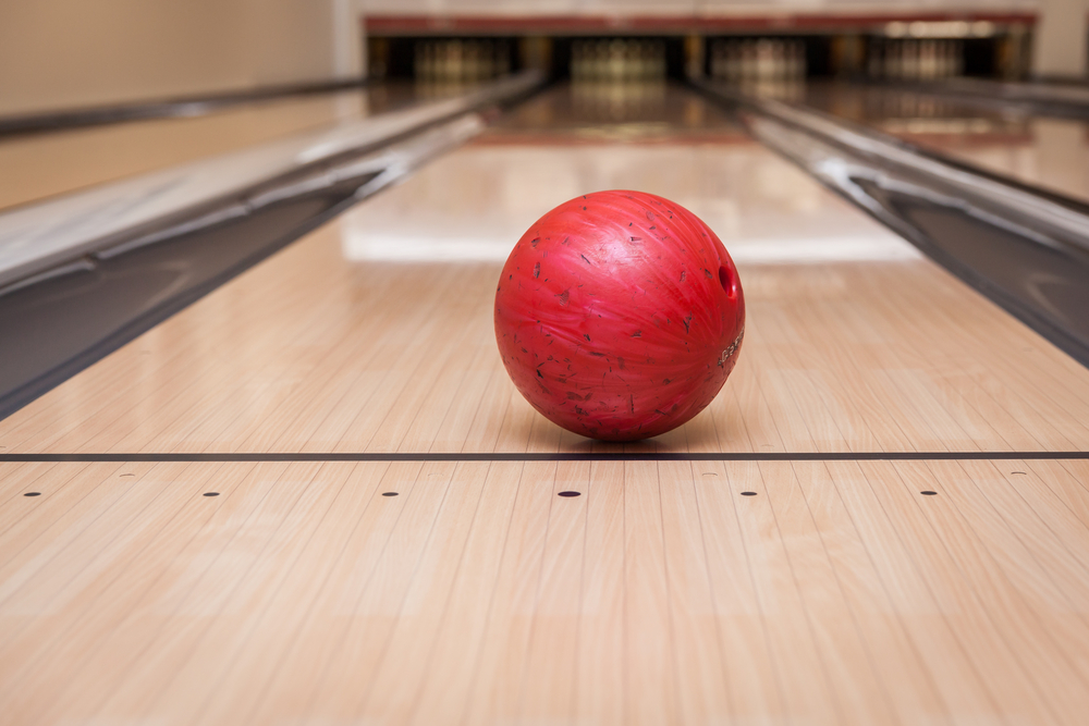 Red bowling ball on kegel recreational bourbon street oil pattern that has more oil in the center than on the sides.
