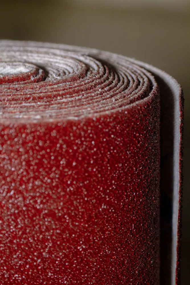 The roll of red sand paper will make a bowling ball perform as if it was a new ball