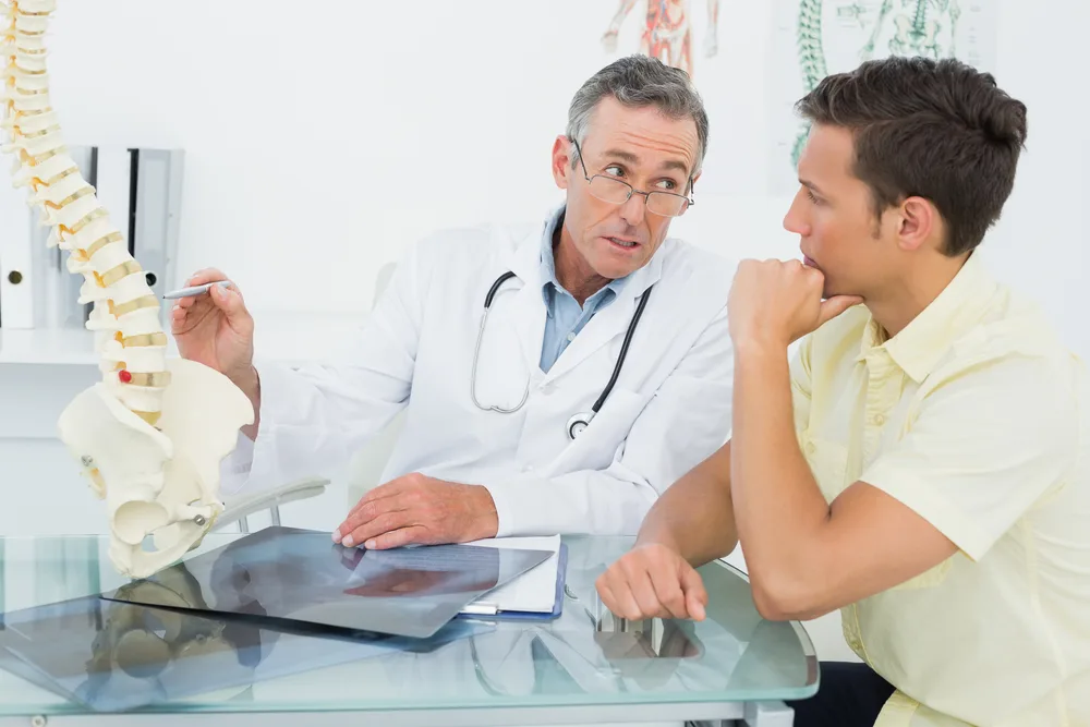 Can You Bowl With A Herniated Disc? What Activities To Avoid (Quick Answer) 1 Doctor explaining to the bowler that too much stress or strenuous exercise can aggrevate most herniated discs