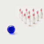 Mini bowling game with white pins and blue ball
