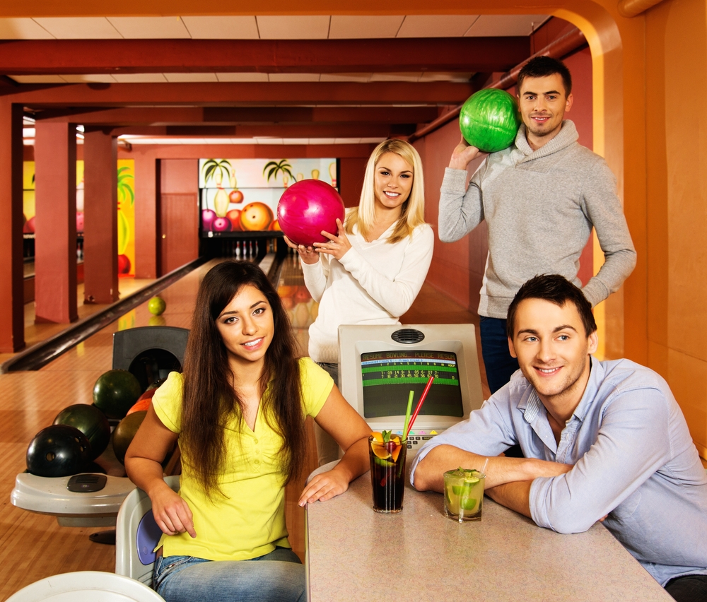 Group of young people behind table in bowling center