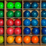 A picture with bowling balls a shelf for the article do bowling alleys sell bowling balls