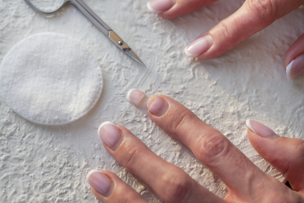 The bowler's natural nails are under the fake nails