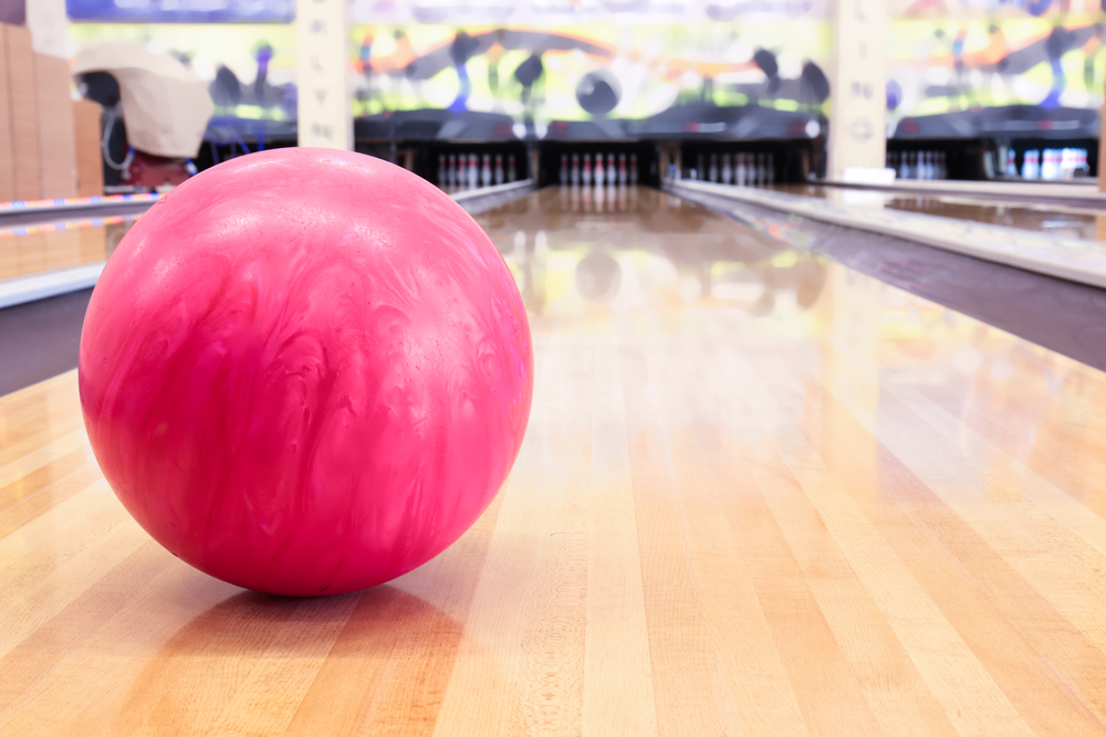 Pink ball on the lane with bowling wax as a protective coating