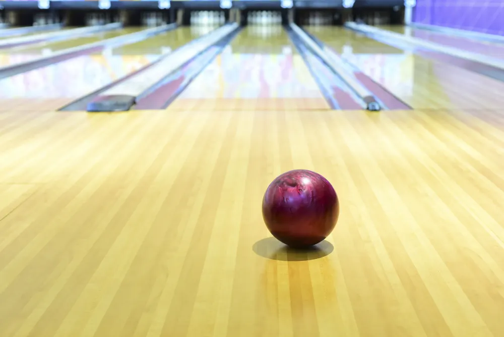 Purple ball on the approach as the bowler tries to figure out the bowling lane conditions