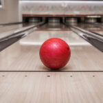 Red bowling ball on lane