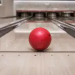 Red bowling ball on lane