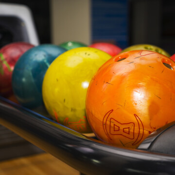 Different colored bowling balls on rack