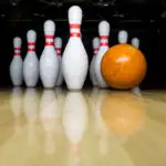 Orange spare bowling ball on bowling lane