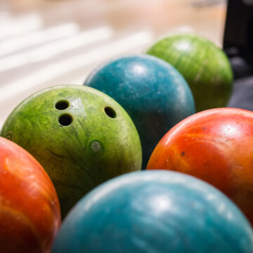 Multi colored bowling ball on ball return