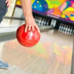 Red bowling ball at foul line