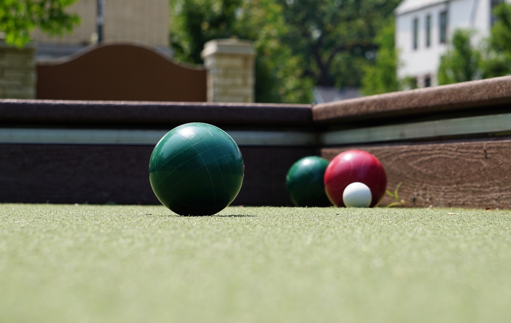 Ground level view of bocce balls and pallino on an artificial turf top surface