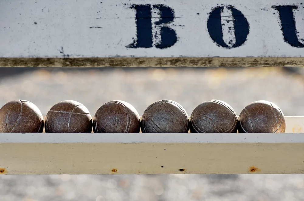Close up of bocce balls on wooden rack