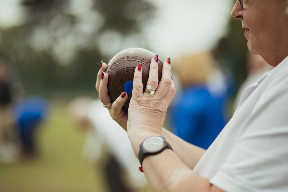 Woman holding a bowl for her second bowl played in the game