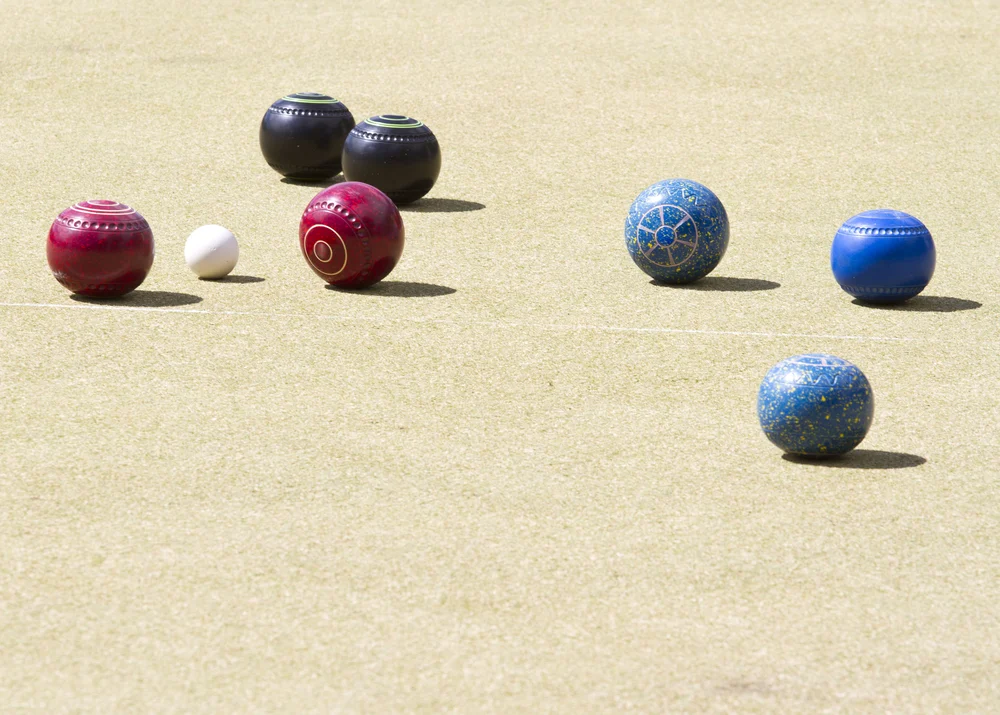 Bowlers on the 4 teams wait to hear the winner of the tournament