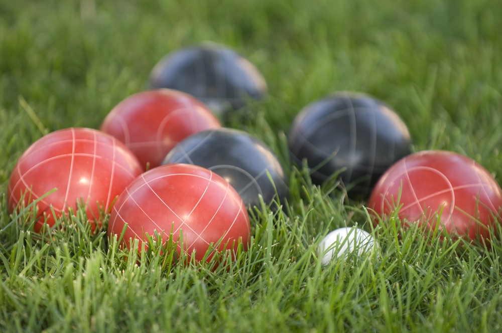 Red team and other team's balls on on green grass