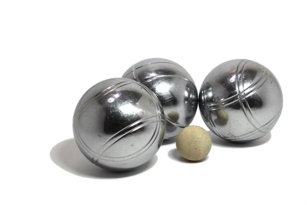Three petanque balls on white background with a jack (cochonnet)