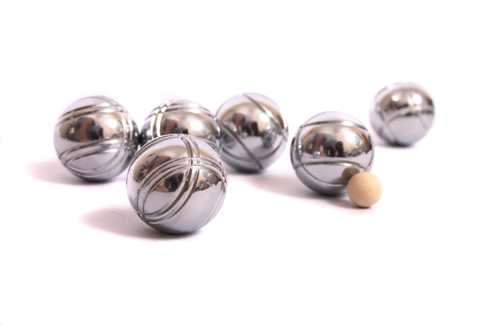 Petanque balls on white background with wooden jack