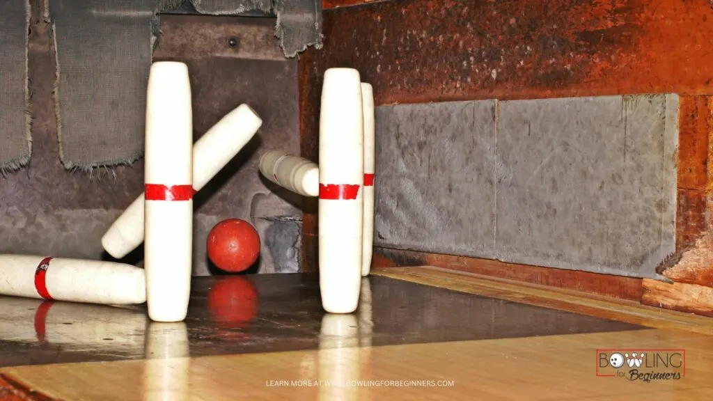 Bowler rolled red candlepin ball and hit several pins