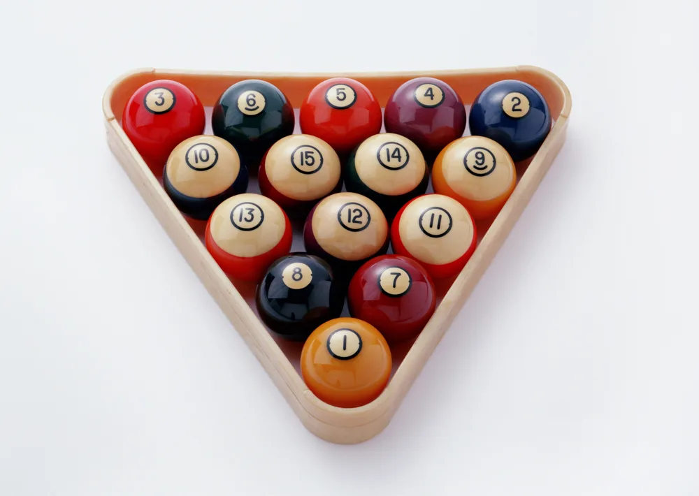 Billiard balls in the rack, numbered 1-15 on a white background