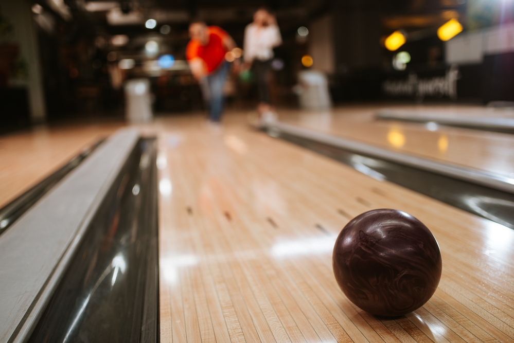 The burgundy ball is rolling down the lane is a part of a set of urethane balls